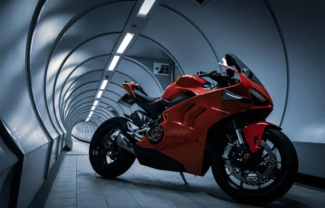 Red Ducati Panigale V2 parked inside a lit pedestrian tunnel
