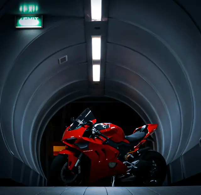 Red Ducati Panigale V2 framed by the mouth of a concrete tunnel