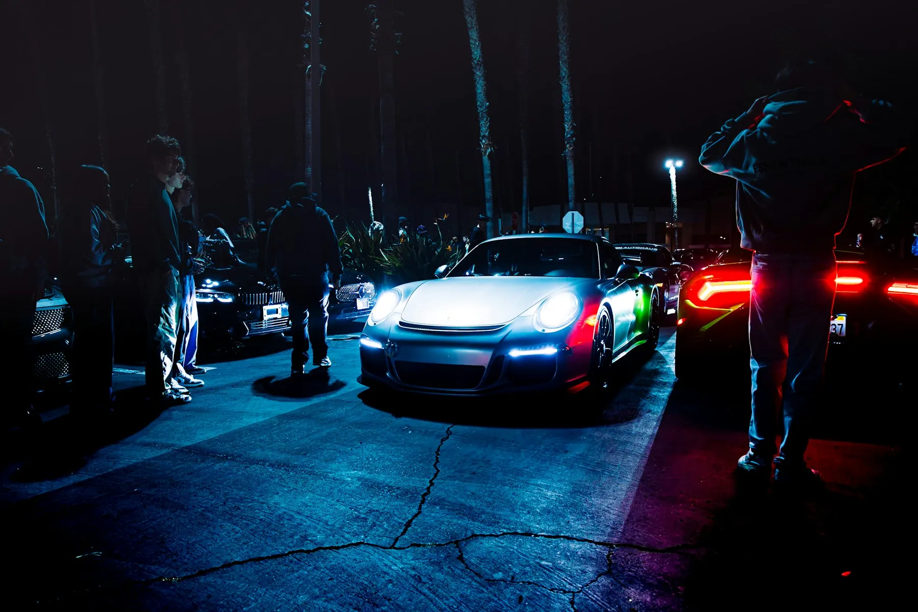 Cars and people gathered at a night car meet