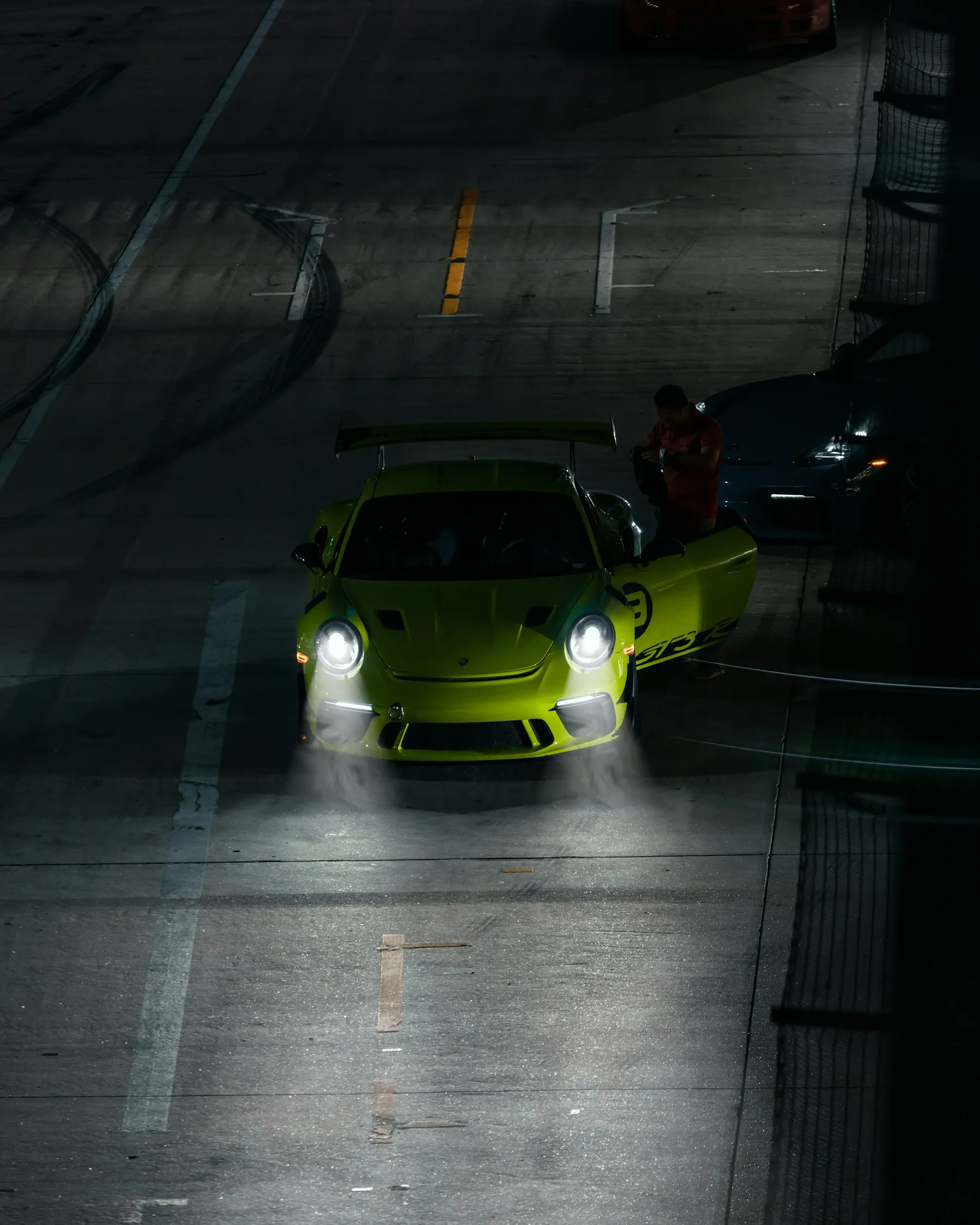 Lime green Porsche GT3 in a tunnel at night